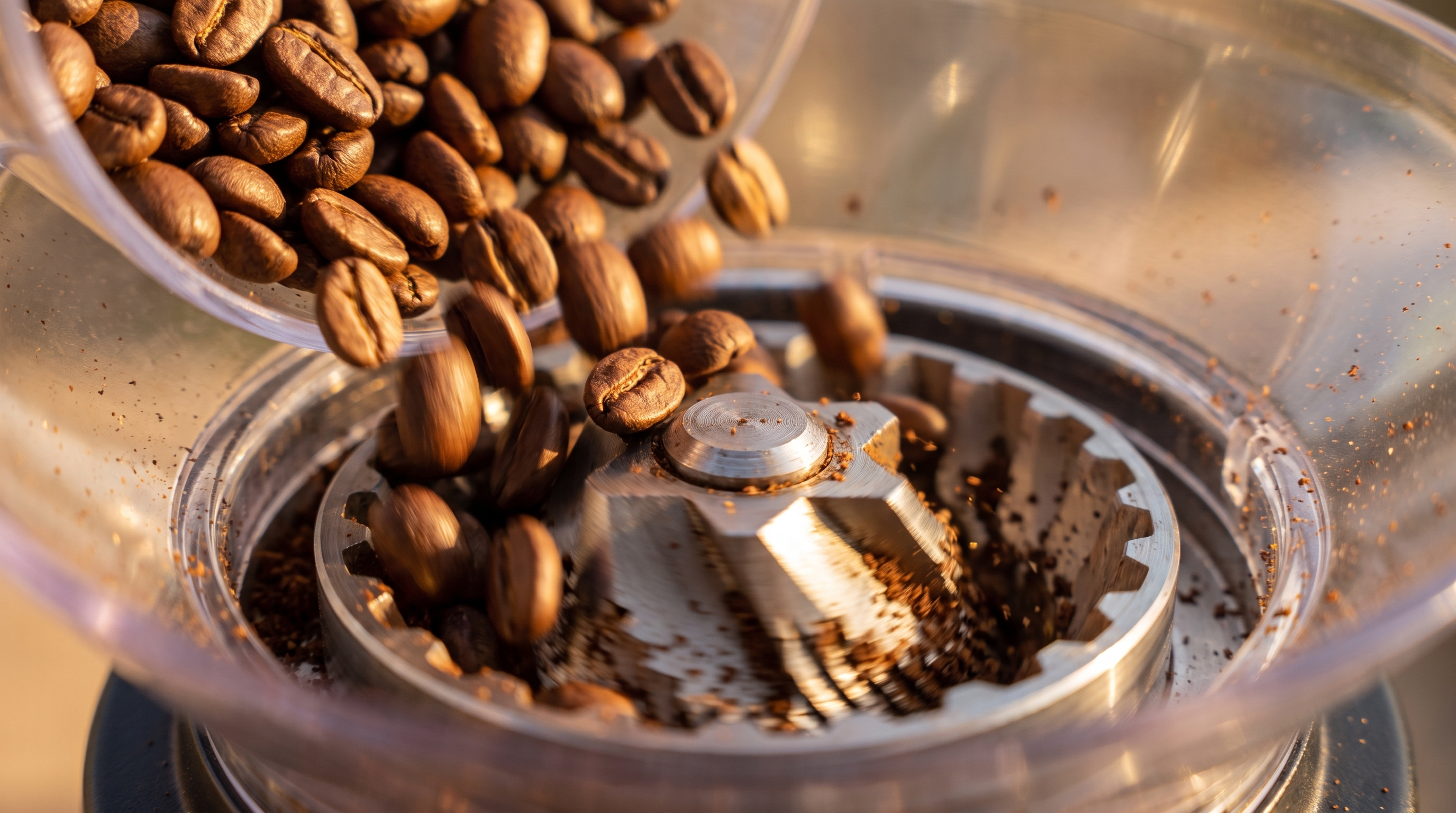 Coffee beans falling into a grinder